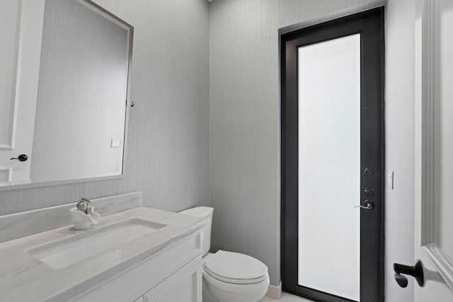 bathroom featuring vanity and toilet