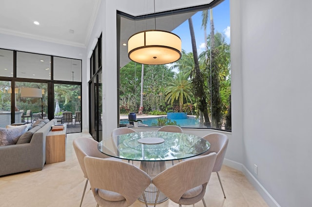 dining space featuring ornamental molding and light tile patterned flooring