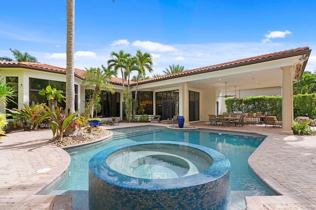 view of pool featuring an in ground hot tub, ceiling fan, and a patio