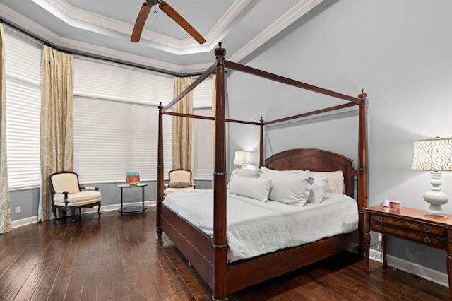 bedroom featuring ceiling fan, a raised ceiling, crown molding, and dark wood-type flooring