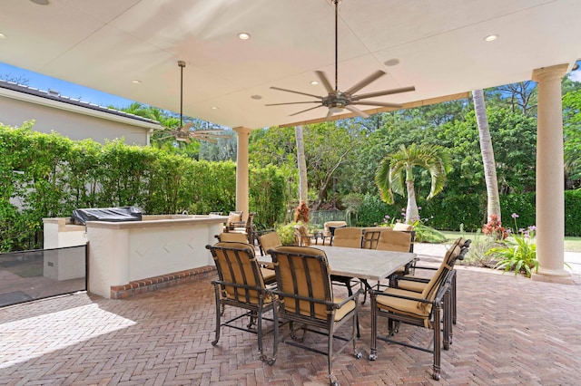 view of patio / terrace featuring a grill, ceiling fan, and an outdoor kitchen