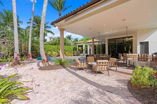 view of patio / terrace featuring ceiling fan and a swimming pool