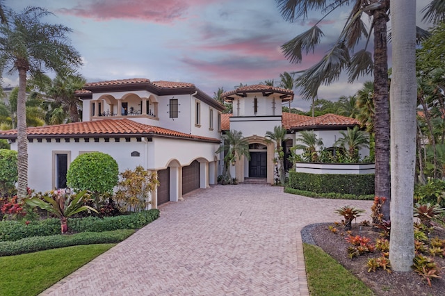 mediterranean / spanish home with a garage