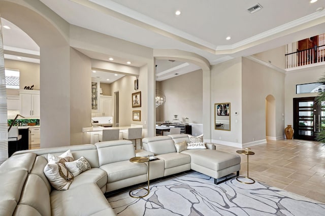 living room featuring a high ceiling and a notable chandelier