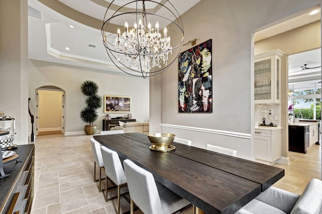 dining area with a raised ceiling