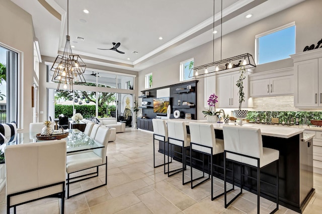 kitchen with white cabinetry, ceiling fan, a healthy amount of sunlight, and decorative light fixtures