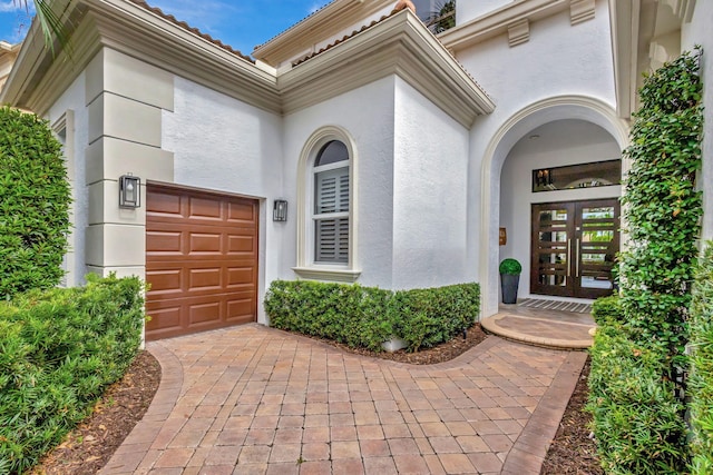 view of exterior entry with a garage