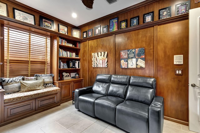 sitting room featuring light tile patterned floors, ceiling fan, and crown molding