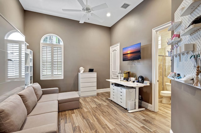 living room with light wood-type flooring and ceiling fan