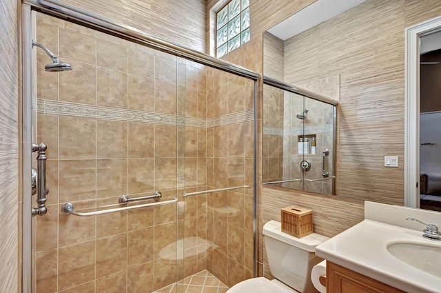 bathroom with vanity, toilet, and an enclosed shower