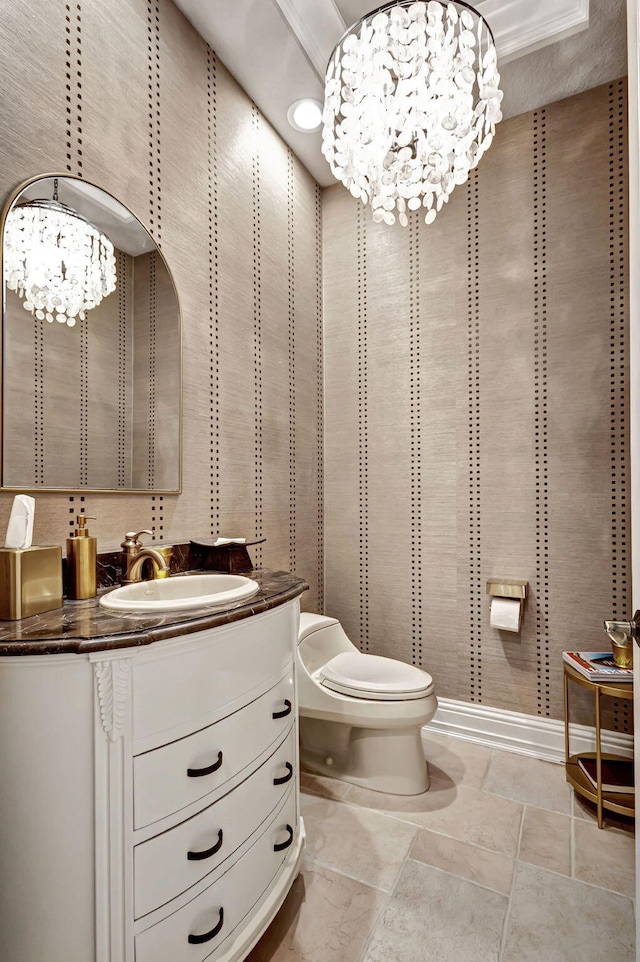 bathroom featuring tile patterned flooring, vanity, a chandelier, and toilet