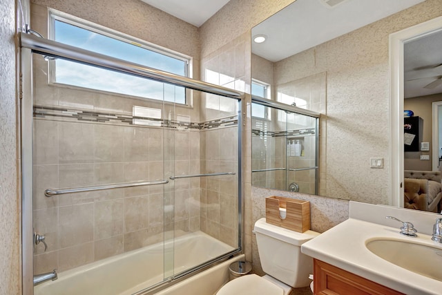 full bathroom featuring vanity, toilet, and bath / shower combo with glass door