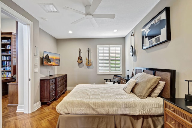 bedroom with ceiling fan and light parquet flooring