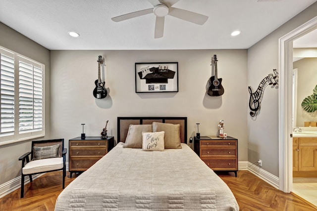 bedroom with ensuite bath, ceiling fan, sink, and parquet flooring