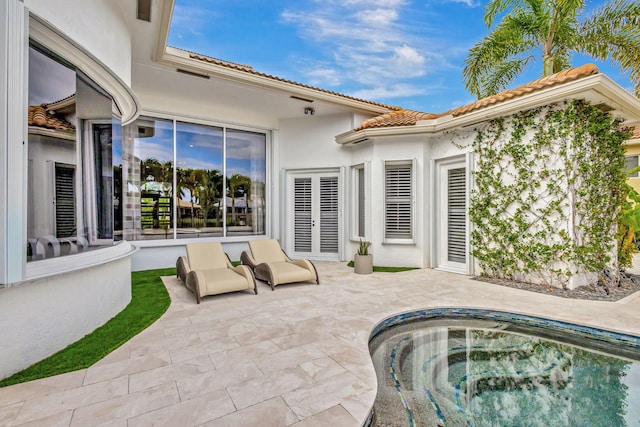 view of patio / terrace featuring a jacuzzi