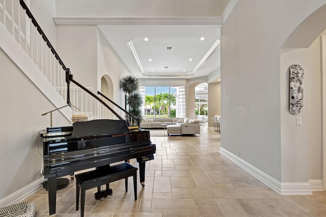 misc room with a raised ceiling and crown molding