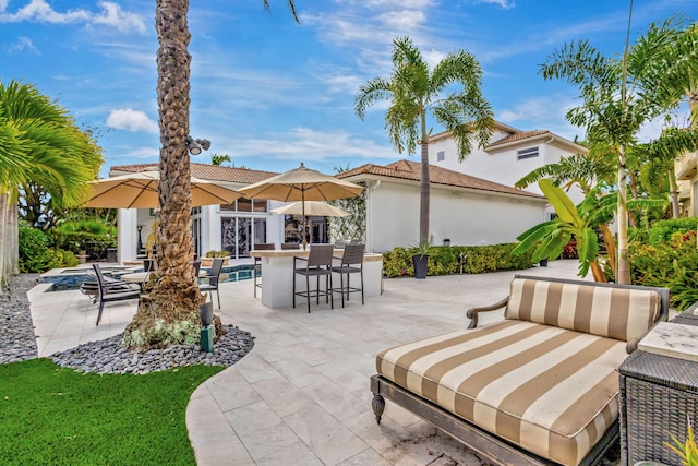 view of patio / terrace with an outdoor living space and an outdoor bar