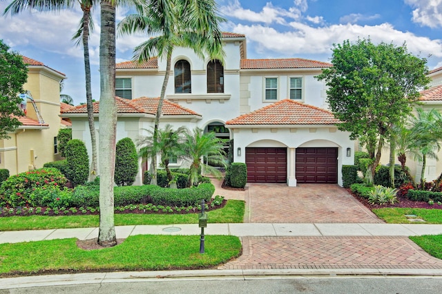 mediterranean / spanish home with a garage