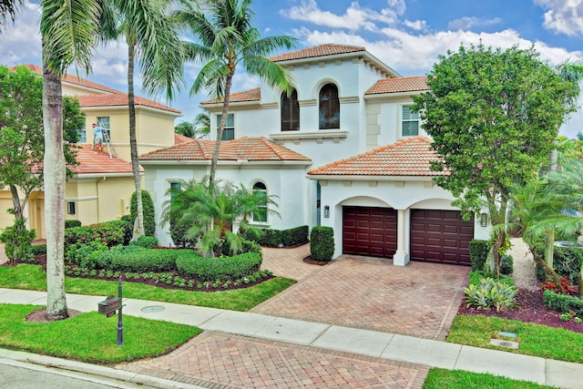 mediterranean / spanish-style house with a garage