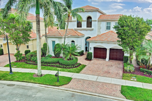 mediterranean / spanish house with a garage