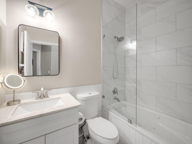 full bathroom featuring toilet, vanity, and tiled shower / bath