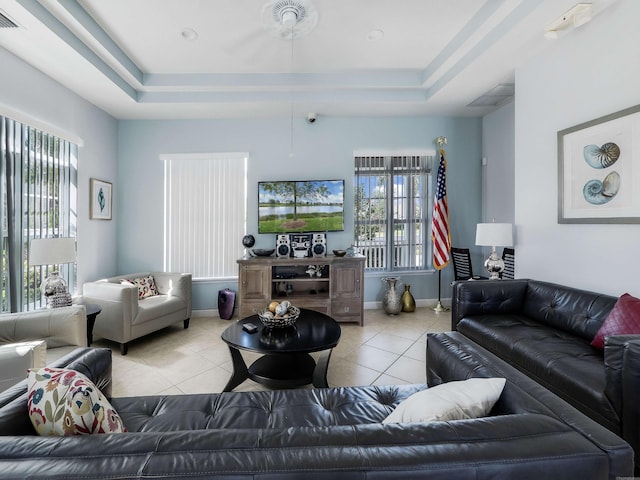 tiled living room featuring a raised ceiling