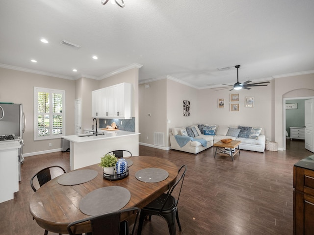 dining room featuring ceiling fan, dark hardwood / wood-style flooring, and ornamental molding