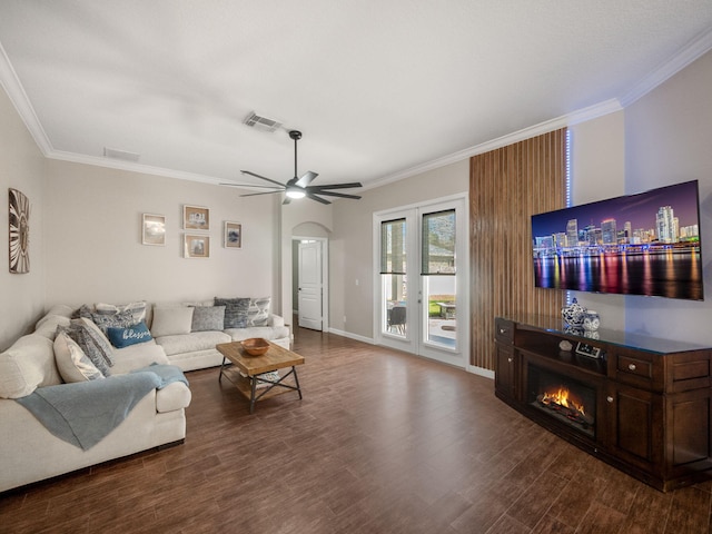 living room with dark hardwood / wood-style floors, ceiling fan, and ornamental molding