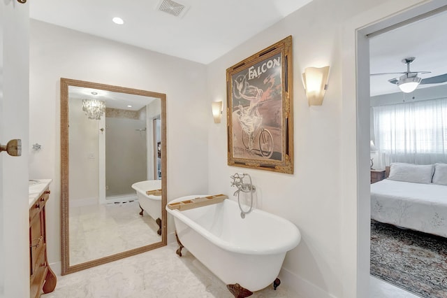 bathroom with vanity, a tub to relax in, and ceiling fan