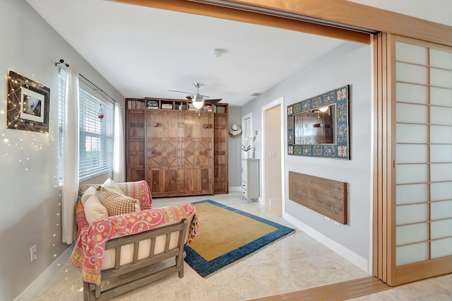 sitting room with ceiling fan