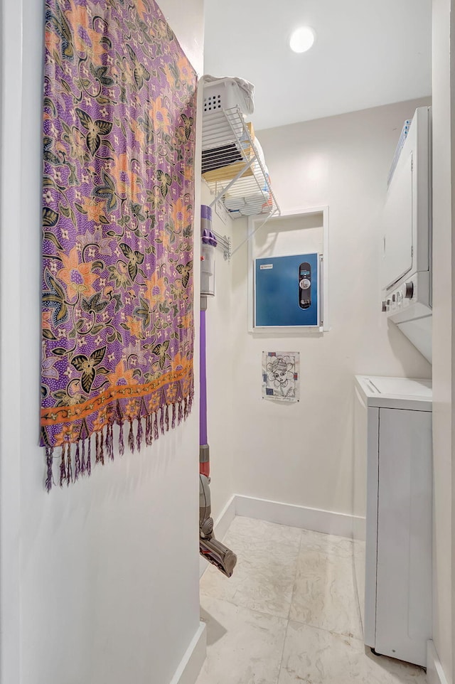 laundry room with stacked washer and clothes dryer