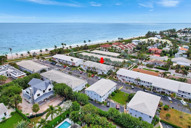 birds eye view of property with a water view and a view of the beach