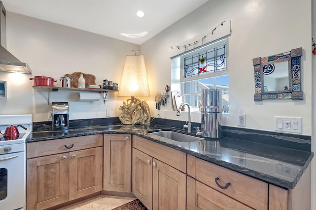 kitchen featuring wall chimney range hood, white electric stove, sink, dark stone countertops, and light tile patterned flooring