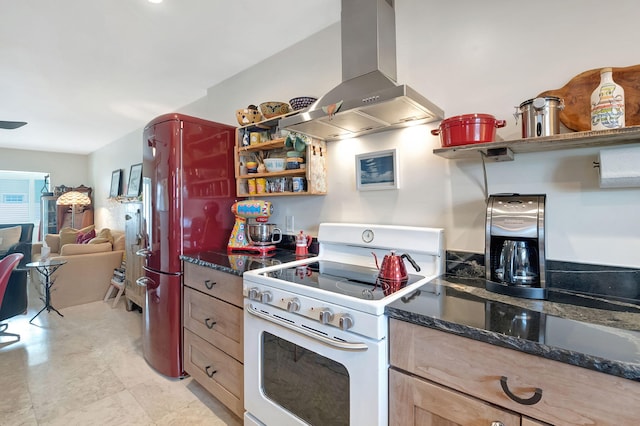 kitchen featuring stainless steel fridge, island range hood, and white range with gas stovetop