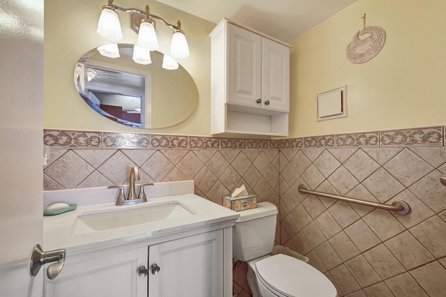 bathroom featuring vanity, toilet, and tile walls