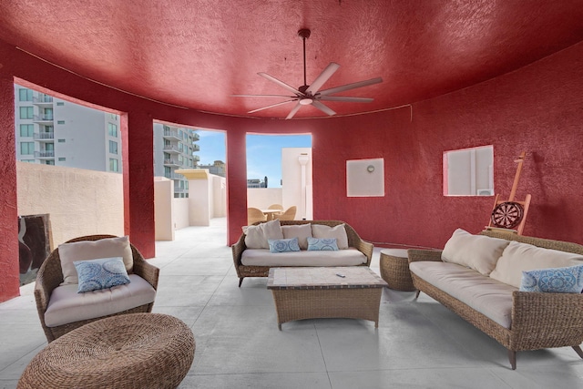 living room featuring a textured ceiling and ceiling fan