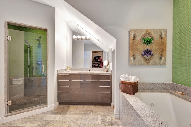 bathroom featuring vanity and separate shower and tub