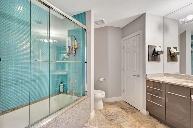 full bathroom with vanity, toilet, and combined bath / shower with glass door