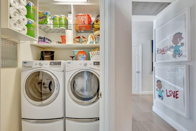 washroom featuring light tile patterned flooring and independent washer and dryer