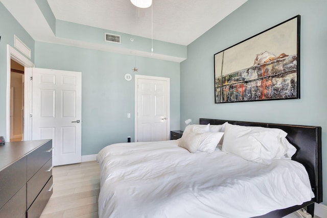 bedroom with ceiling fan and light wood-type flooring