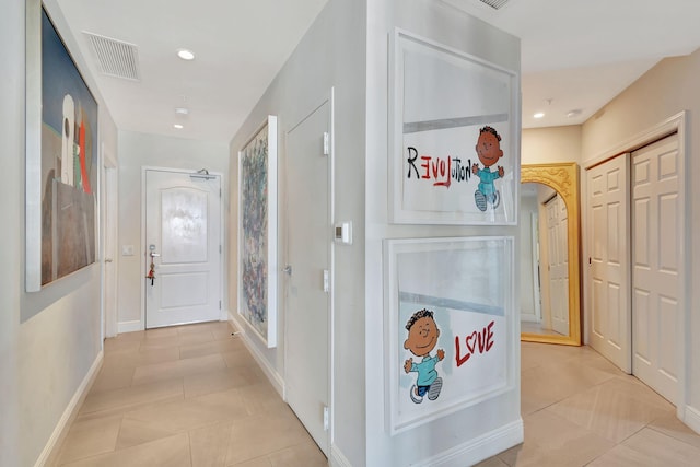 corridor featuring light tile patterned floors