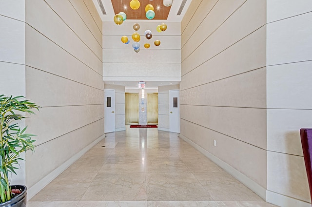 hall with a high ceiling and wooden walls