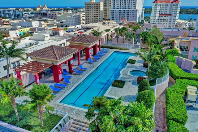 view of swimming pool with a hot tub, a pergola, and a patio