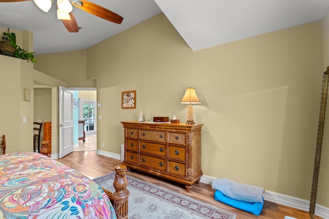 bedroom with ceiling fan, light hardwood / wood-style floors, and high vaulted ceiling