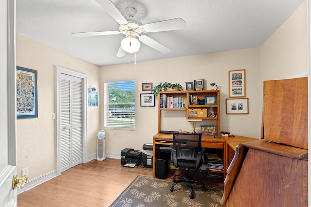 home office featuring ceiling fan and light hardwood / wood-style floors