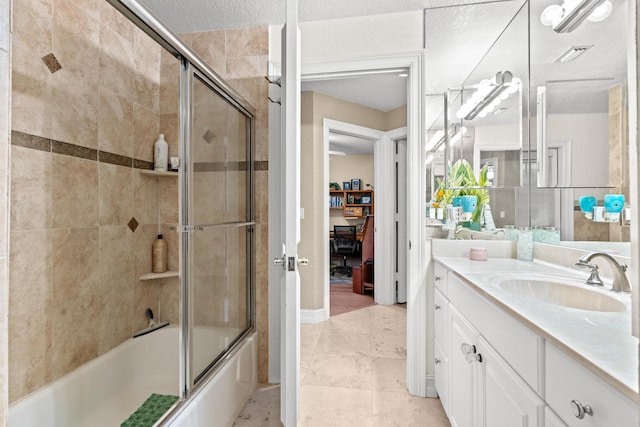 bathroom featuring combined bath / shower with glass door, a textured ceiling, vanity, and tile patterned floors