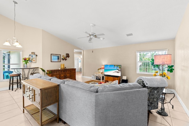 living room featuring light tile patterned floors, ceiling fan with notable chandelier, and lofted ceiling