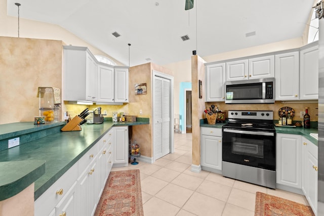 kitchen featuring white cabinetry, vaulted ceiling, and appliances with stainless steel finishes