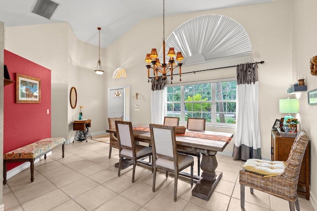 dining area with light tile patterned floors, high vaulted ceiling, and an inviting chandelier