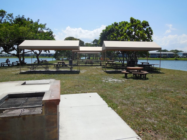 view of community featuring a gazebo, a water view, and a lawn